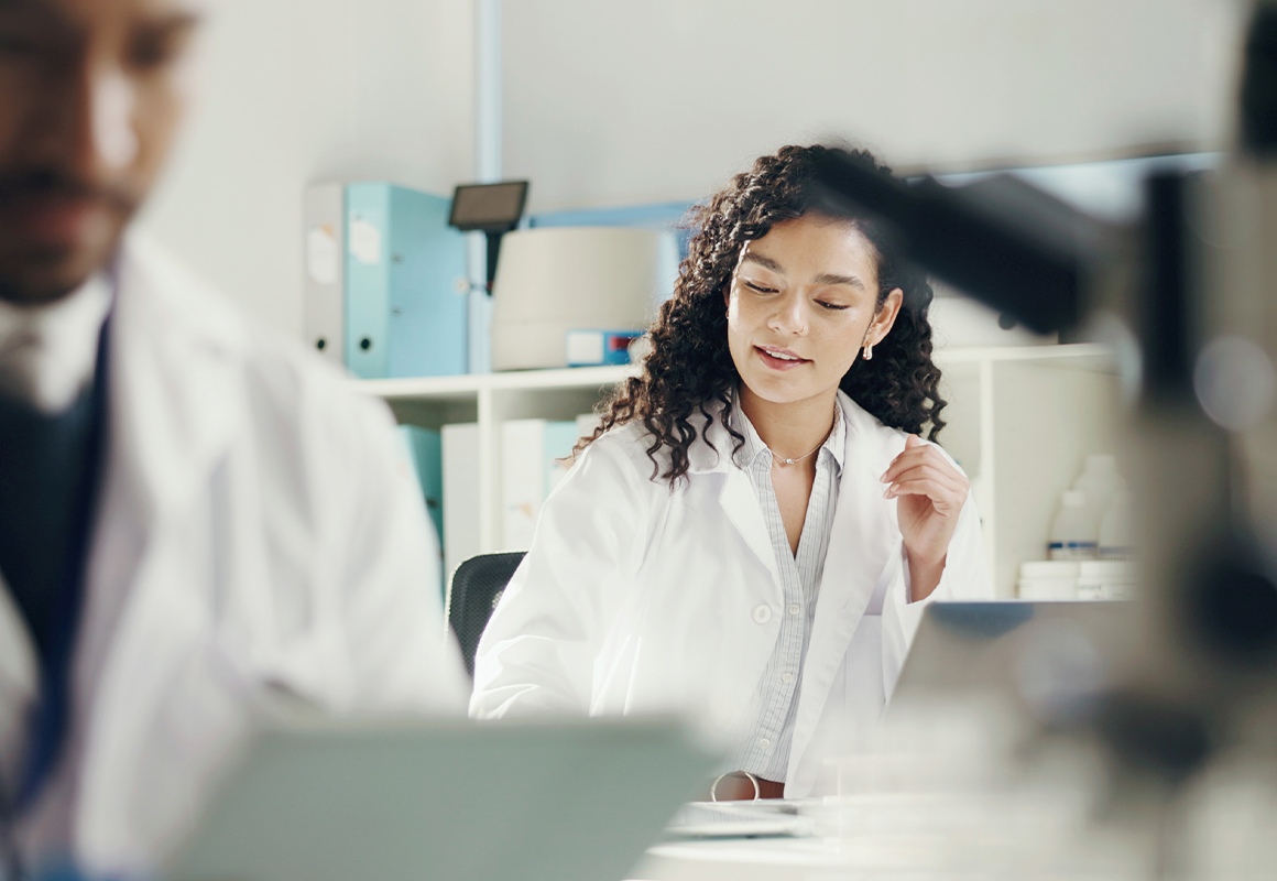 woman smiling in a white coat