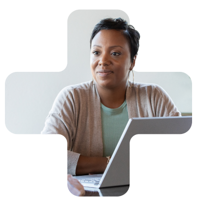 woman smiling in front of her laptop