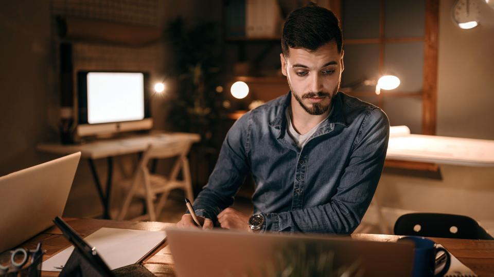 Man working at desk with laptop