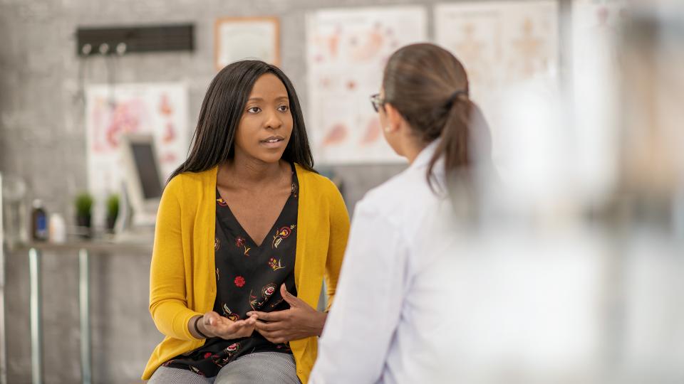 Patient discusses her care with a clinician