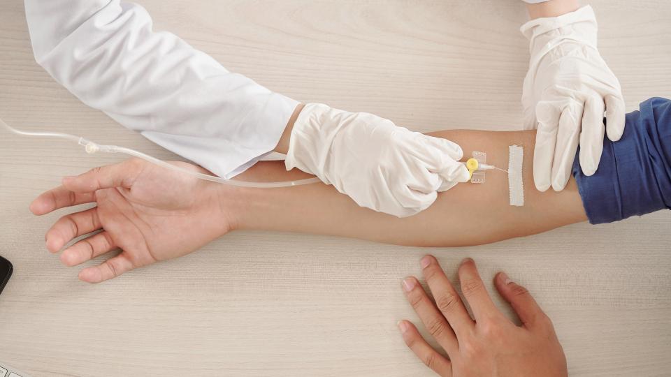Medical professional administers an infused medication