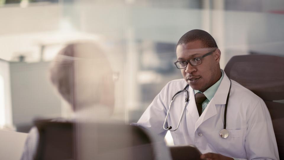 Two physicians in an office having a conversation