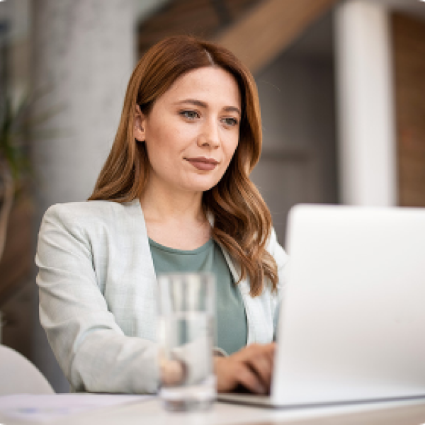 woman sits at laptop