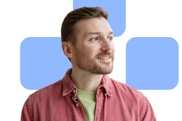 A smiling man in a red shirt with yellow undershirt