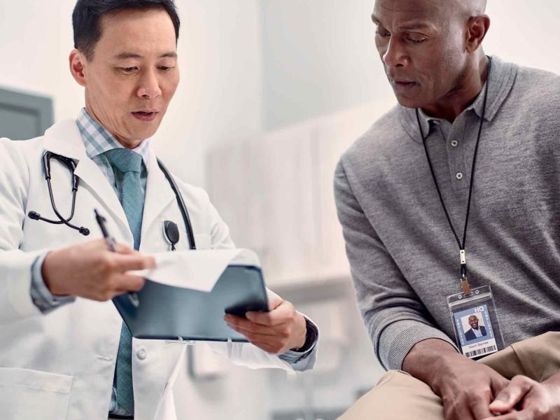 Doctor discussing chart with patient in-person