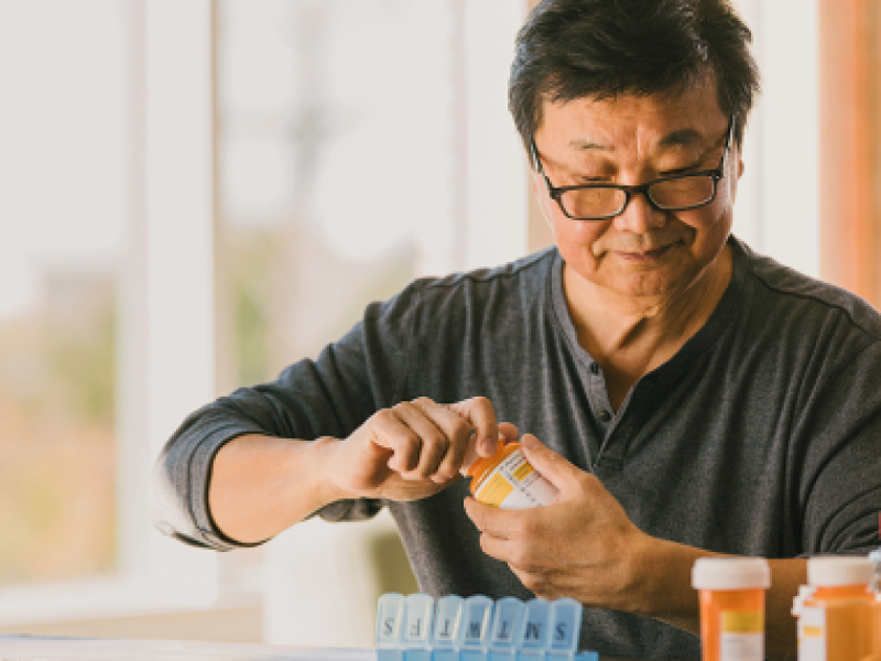 man with pill bottle
