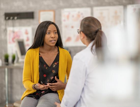 Patient discusses her care with a clinician