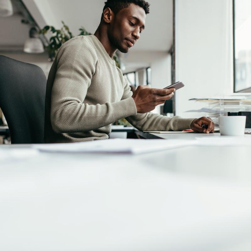Man sitting at home talking to his doctor on a mobile device