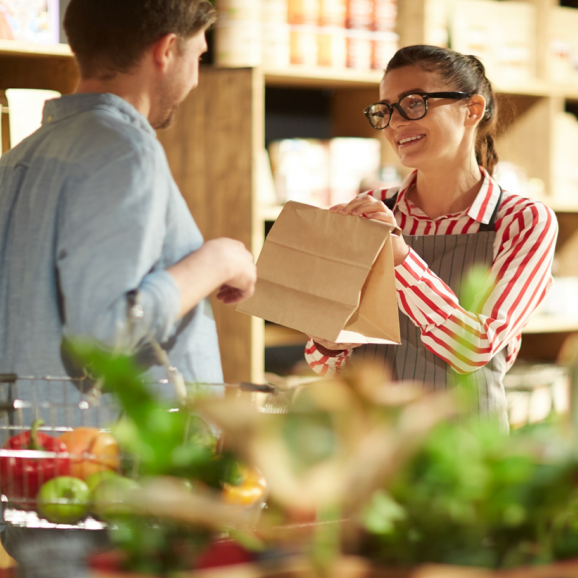 grocery store clerk assisting a customer