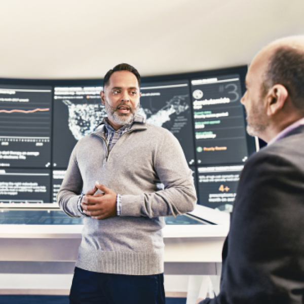 Two healthcare business associates discussing data intelligence for patients